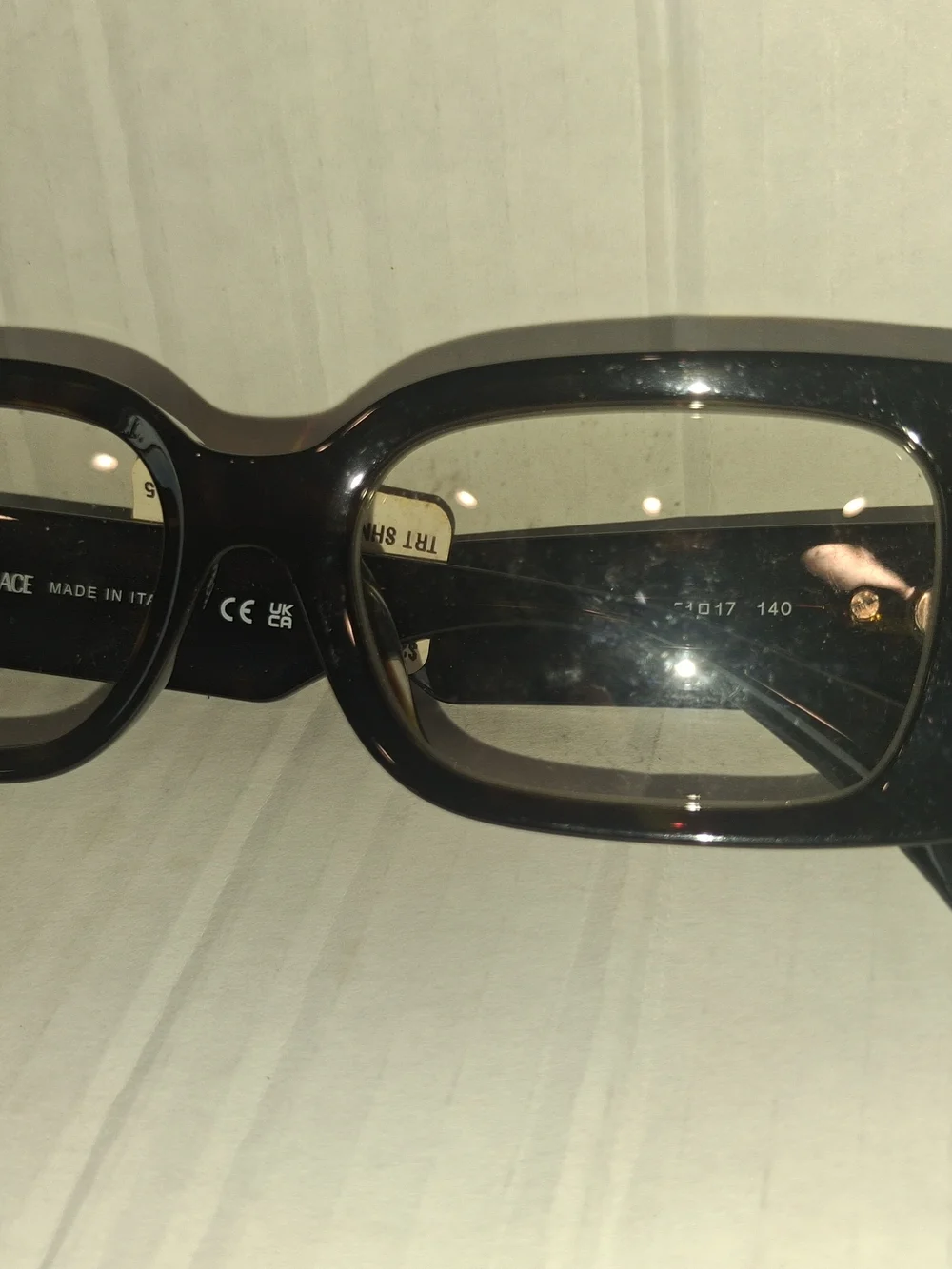Versace VE3362U eyeglasses feature a bold, rectangular black frame with thick te